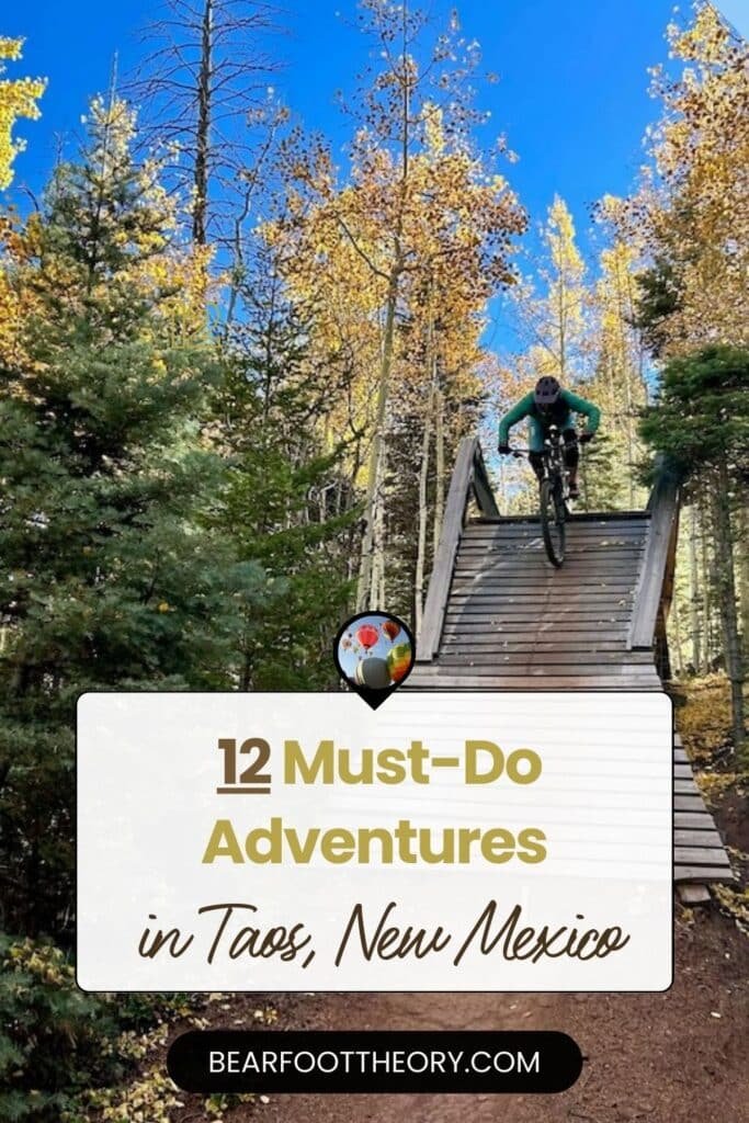 Mountain biker riding off wooden ramp next to golden aspen trees. Text reads "12 must-do adventures in Taos, New Mexico"