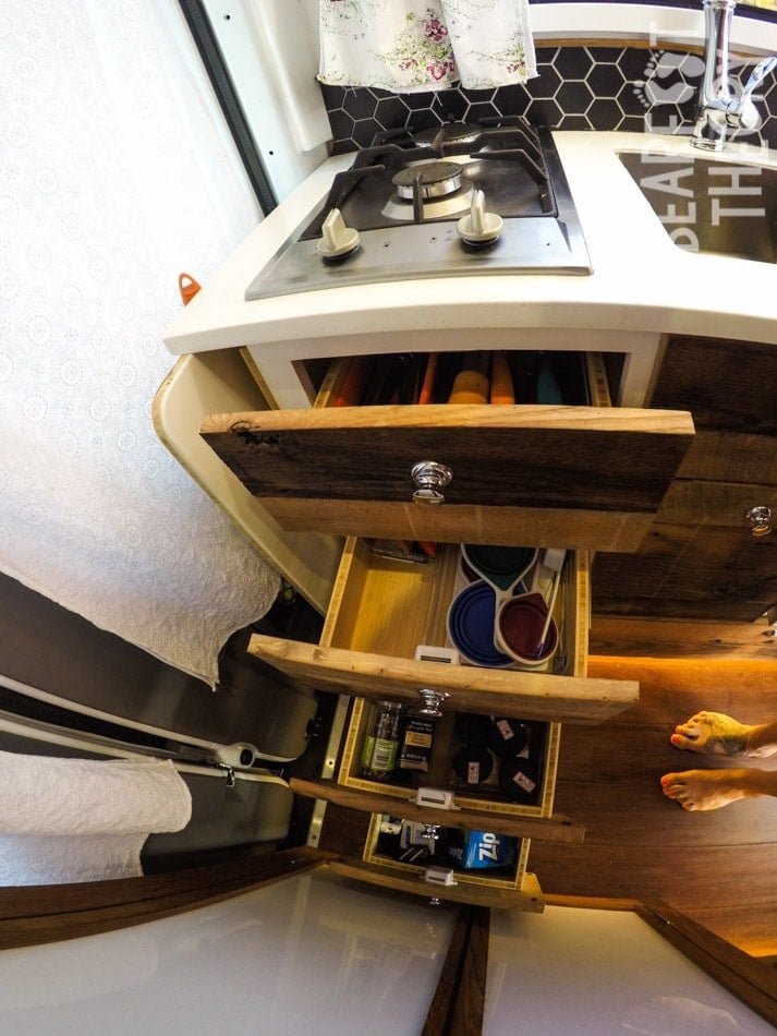 Drawers in the galley open to show storage space in Alaina's first 4x4 merecdes sprinter van