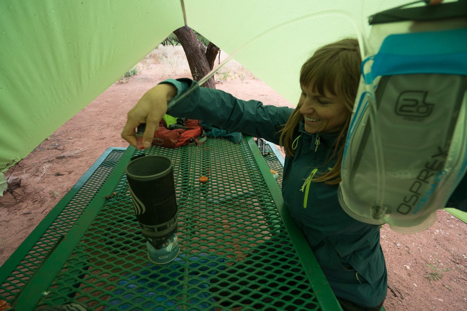 Alaina filling Jetboil backpacking stove on picnic table at Havasu Falls campsite from hydration water reservoir
