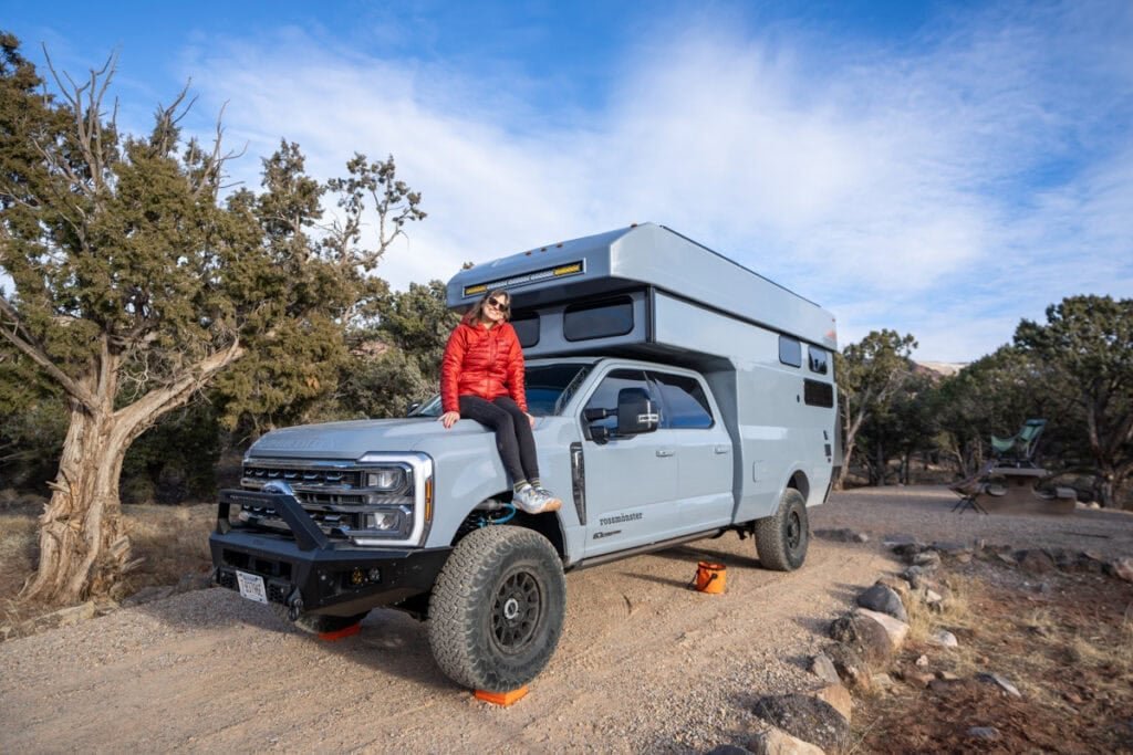Alaina Hermiston sitting on the front of the Rossmonster Baja LX Adventure Truck