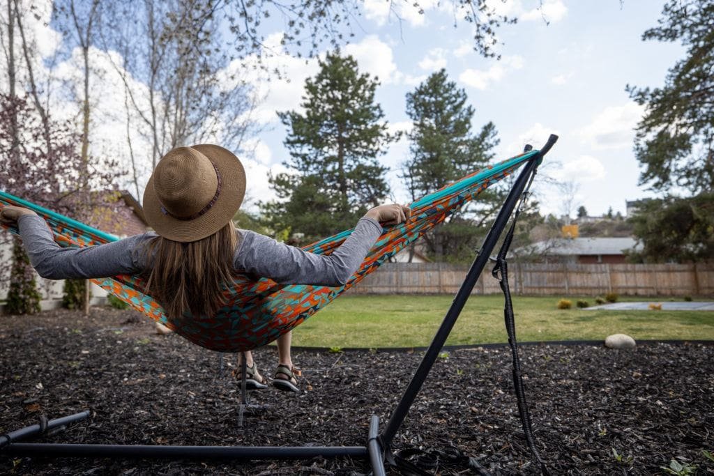 Terrain Spark founder Alaina Hermiston swinging in a colorful ENO hammock in her backyard