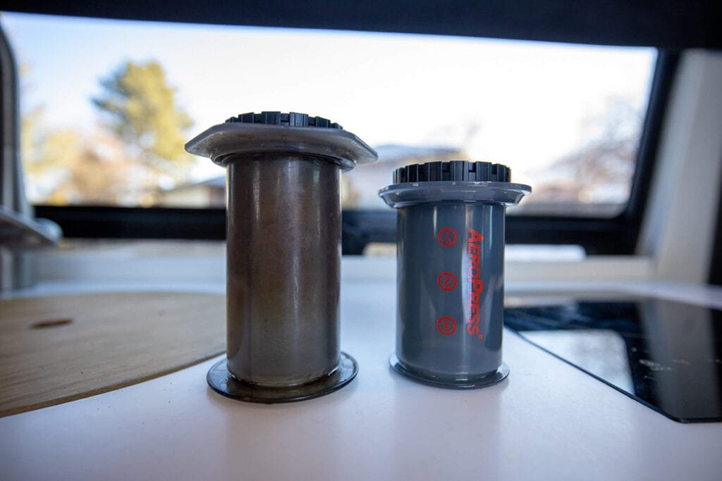 The original AeroPress next to the travel AeroPress Go on a countertop