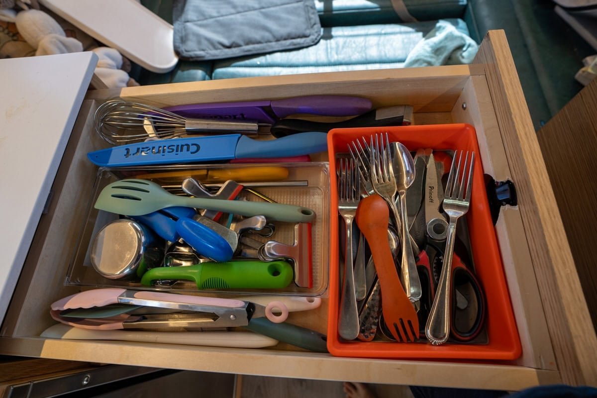 Cooking utensils in a drawer in a camper van