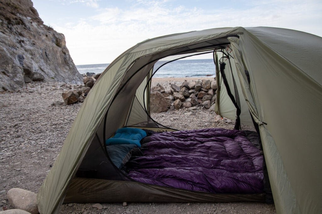 Enlightened Equipment Accomplice 2-Person Backpacking Quilt in a tent on the beach on Catalina Island