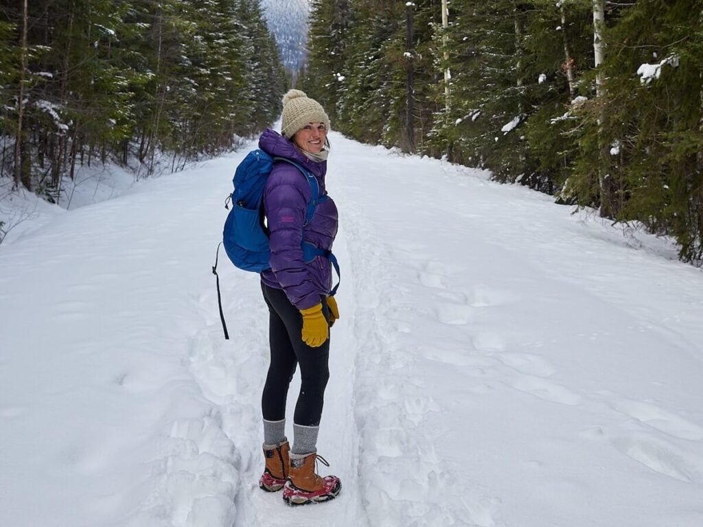 BFT founder Alaina Hermiston hiking in the snow on the Golden Wapta Falls Trail. She is wearing warm hiking gear including a puff jacket and winter boots.