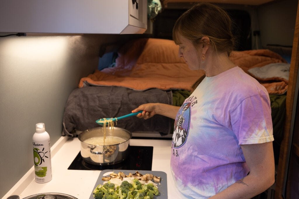 Alaina Hermiston cooking in her sprinter van