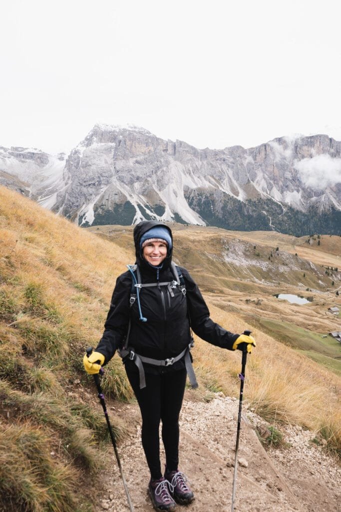 Alaina Hermiston wearing the Outdoor Research Aspire II Rain Jacket while hiking in the Italian Dolomites