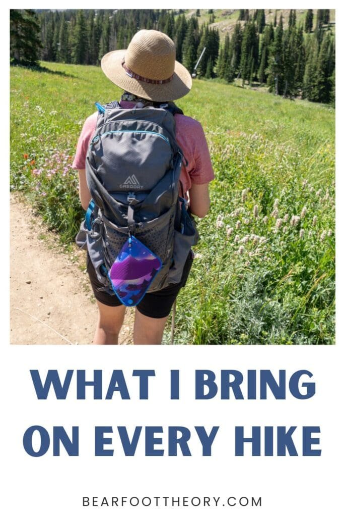 Alaina Hermiston hiking at Alta Ski area in summer with a gray backpack on. Text reads What I bring on every hike.