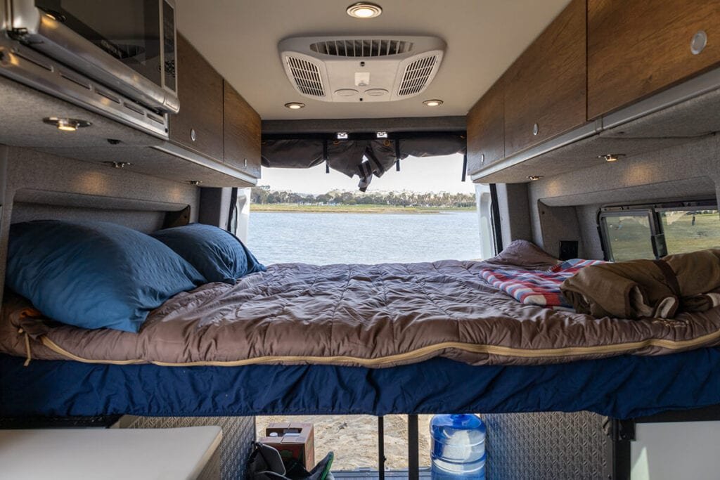 REI  Co-op Siesta Double Sleeping Bag set up in a camper van with the back doors open