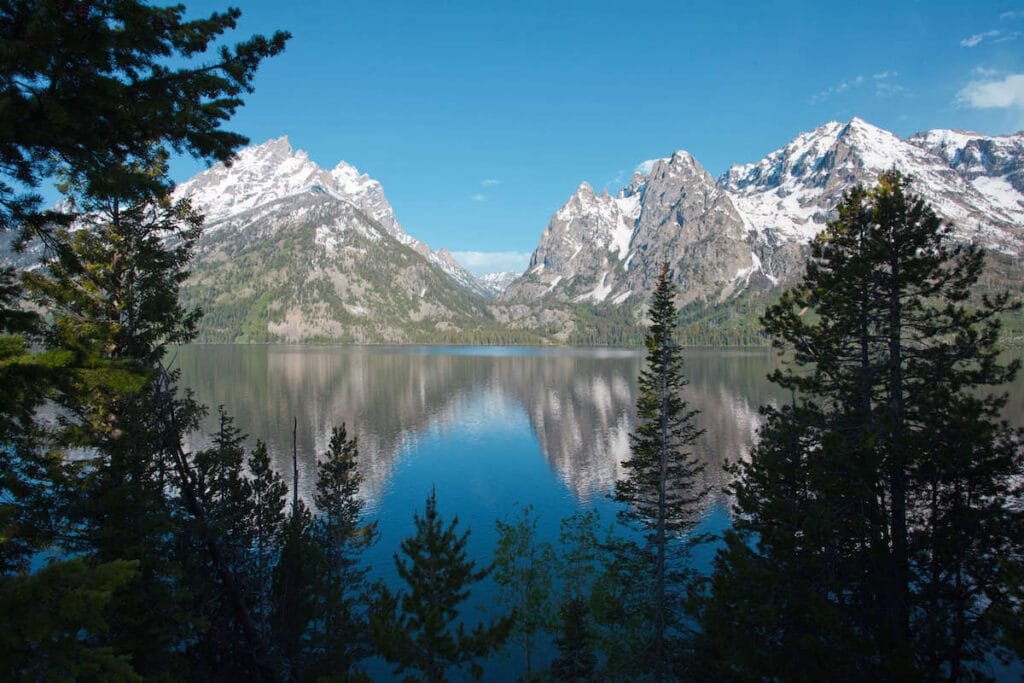 Jenny Lake and Cascade Canyon through the trees in Grand Teton National Park in Wyoming