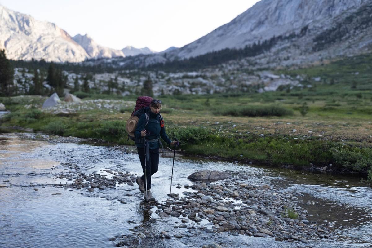 Alaina Hermiston backpacking across a stream in Sequoia National Park