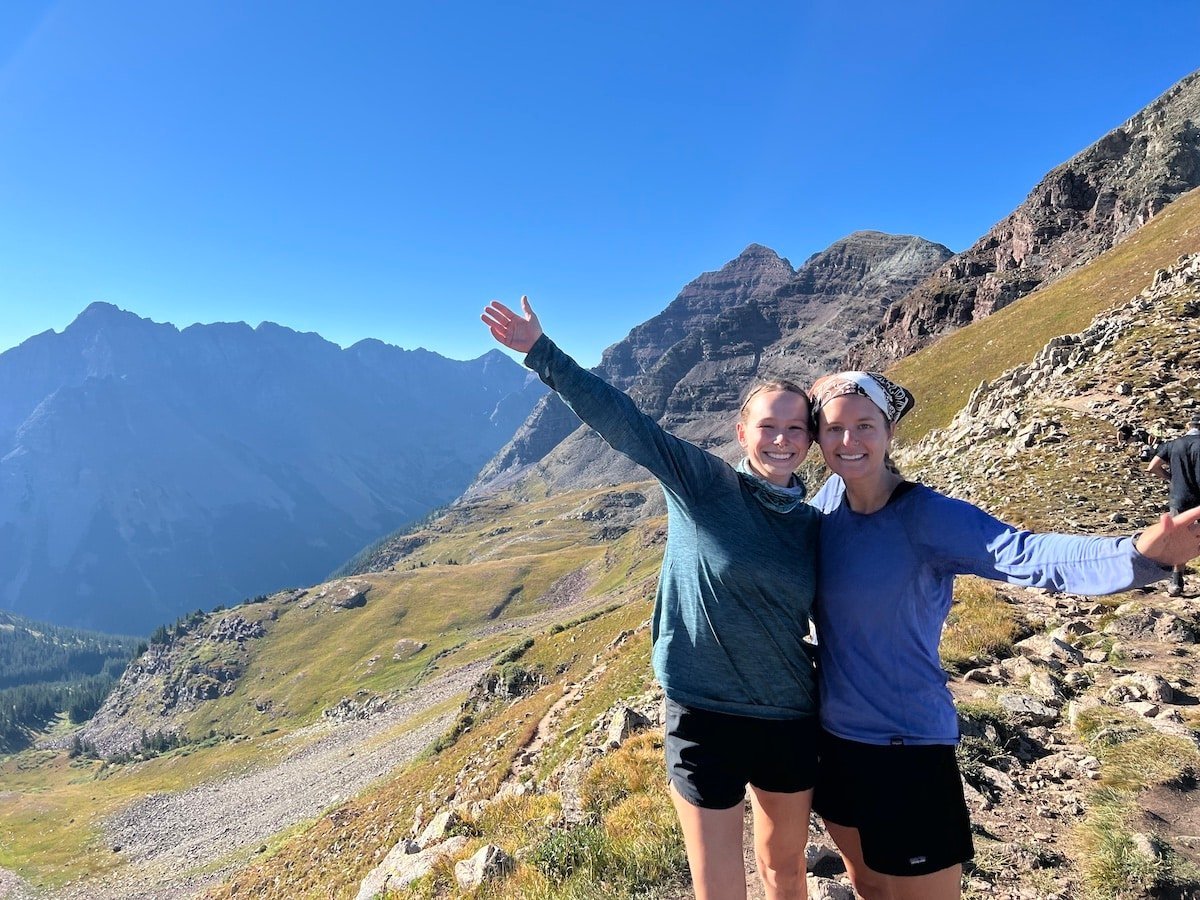 Two hikers on the summit of Buckskin Pass on the Four Pass Loop.