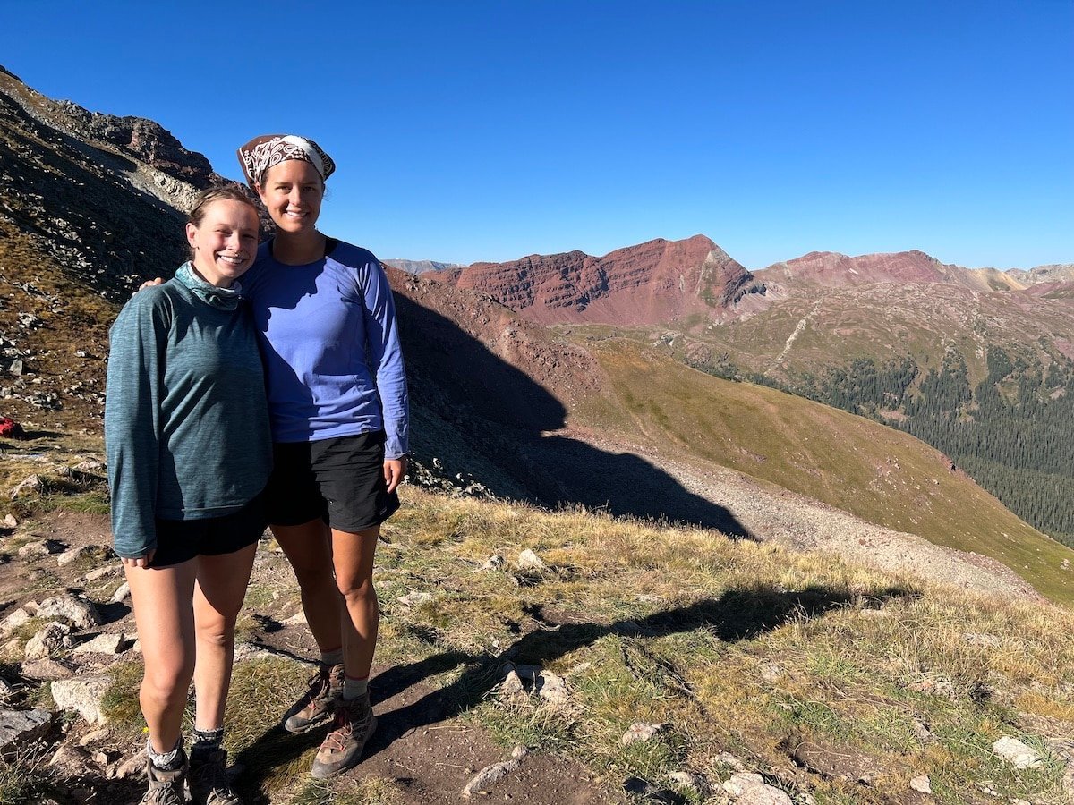 Two hikers on the top of Buckskin Pass on the Four Pass Loop.