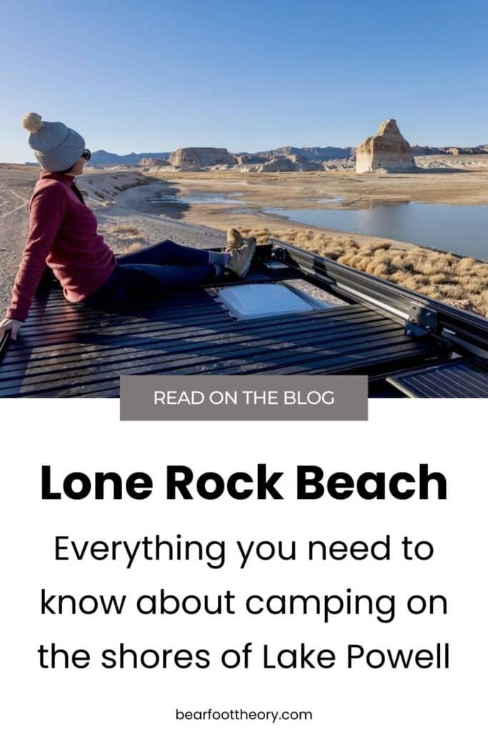 Pinnable image of woman sitting on top of converted camper van looking out over rock monolith at Lone Rock Beach Campground. Text reads "Lone Rock Beach: Everything you need to know about camping the shores of Lake Powell"