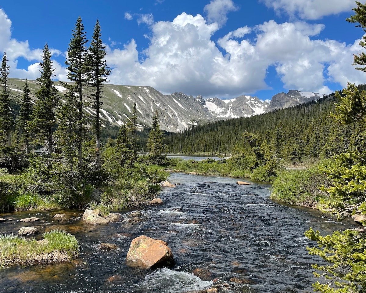 Water crossing with a mountain and trees on the trail of Lake Isabelle in Colorado