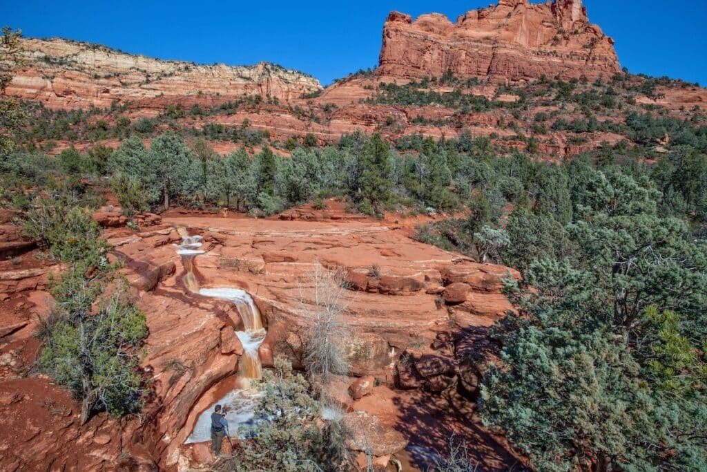 Waterfall cascading over red sandstone rocks in Sedona, Arizona