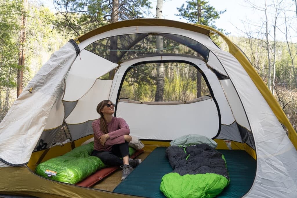 Alaina Hermiston sitting inside the REI Base Camp 4 Tent
