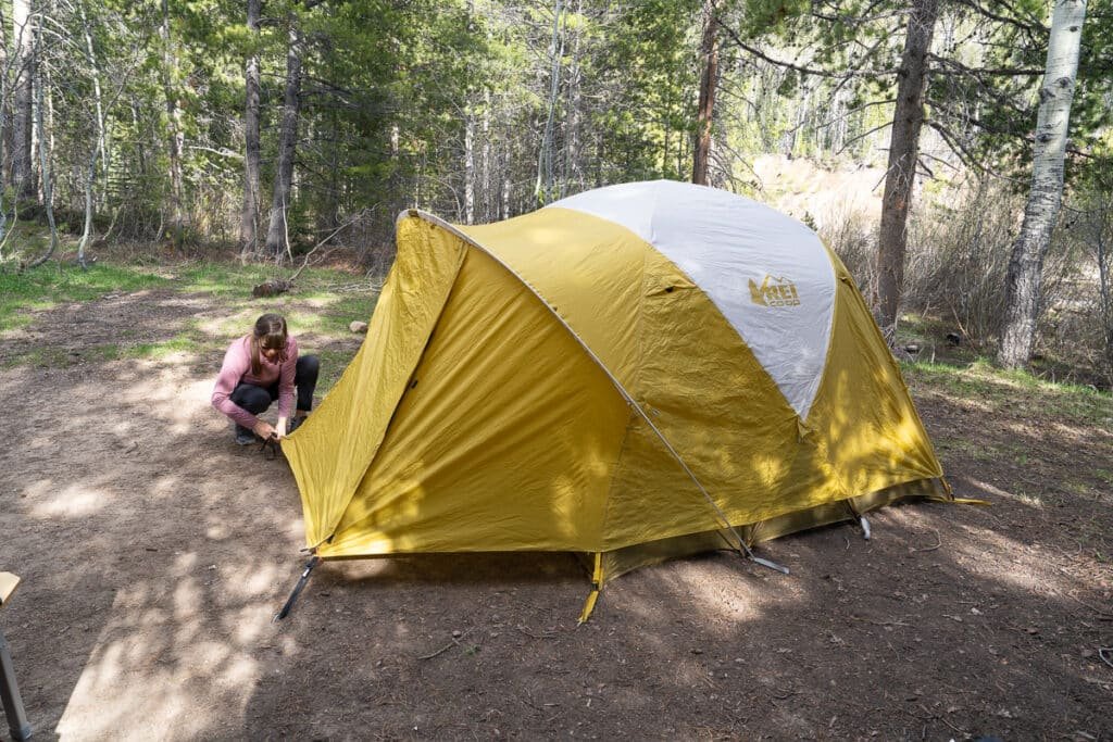 Alaina Hermiston setting up the REI Base Camp 4 tent