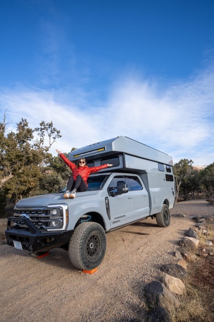 Alaina Hermiston sitting on the front of the Rossmonster Baja LX Adventure Truck